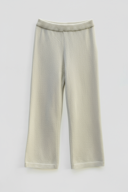 Cleaned beige knitted pants with off-white background